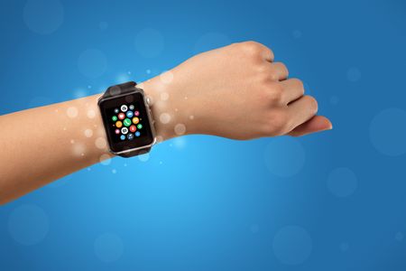 Naked female hand with smartwatch and with application icons on it