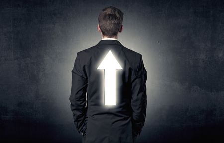 Young businessman standing and thinking about which direction to choose