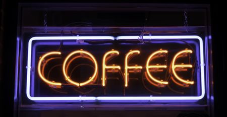 Neon sign in window of store: COFFEE
