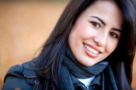 Portrait of a casual woman smiling outdoors