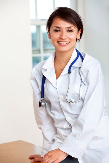 Young female doctor smiling at her practice