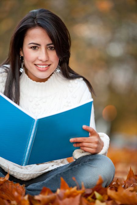 Female studying outdoors during the fall or autumn period