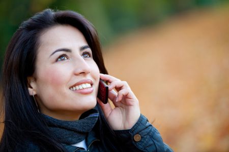 Woman talking on her mobile phone outdoors