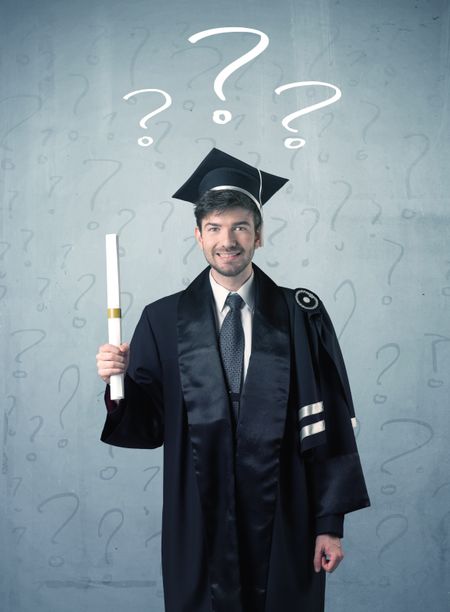 Young graduate teenager with question marks drawn over his head