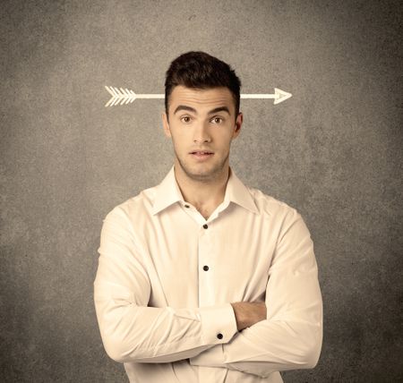 A confused young business guy giving thumbs up with a drawn arrow going through his head concept