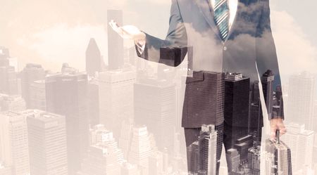 Handsome business man with overlay cityscape background