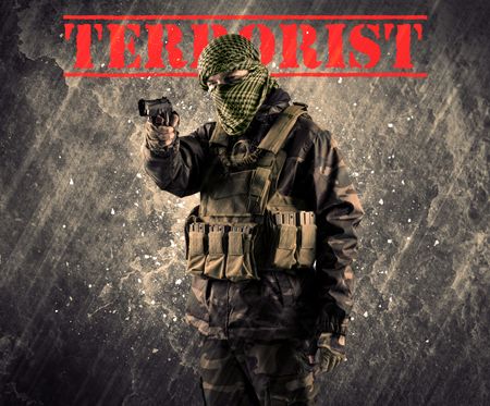 portrait-dangerous-masked-armed-man-terrorist-648420742 Portrait of dangerous masked and armed man with terrorist sign on grungy background
