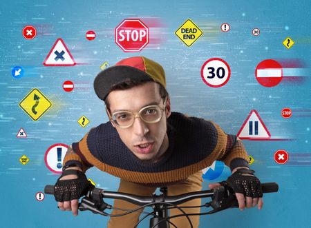 Young guy with stylish outlook and highway code on the background