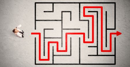 Lost businessman found the way in maze with red arrow on grungy background