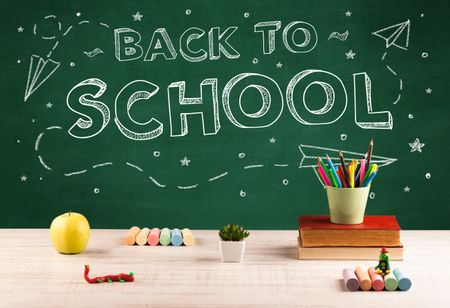 Back to school concepty with writing on blackboard and desk, apple, books, items