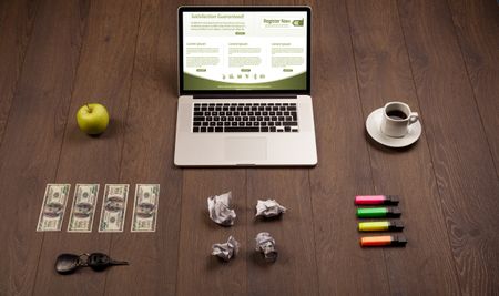 Business wooden table with notebook computer and office accessories