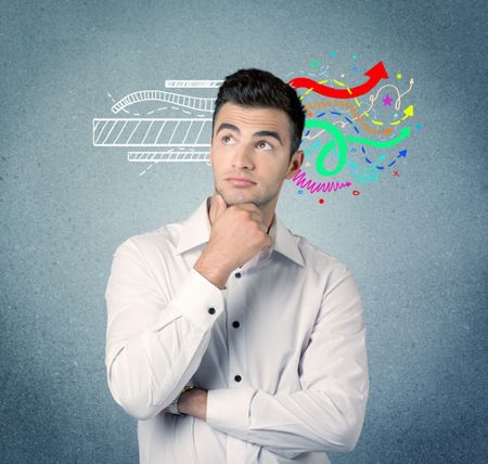 A handsome sales person standing in front of a blue  urban concrete wall with illustration expressing creativity by transforming white lines to colorful arrows cocncept