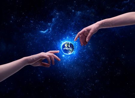 Male god hands about to touch the earth globe in the galaxy with bright shining stars and blue light illustration concept. Elements of this image furnished by NASA.