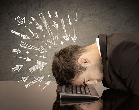 An exhausted business person resting his head on keyboard with pressure illustrated by arrows pointing at him concept