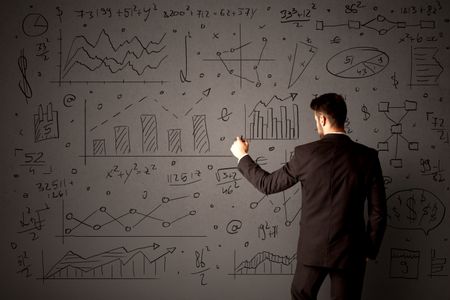 Young businessman in black suit standing in front of detailed calculations 