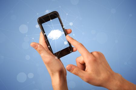 Female fingers touching smartphone with cloud concept
