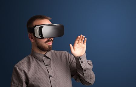 Amazed businessman with virtual reality goggles 