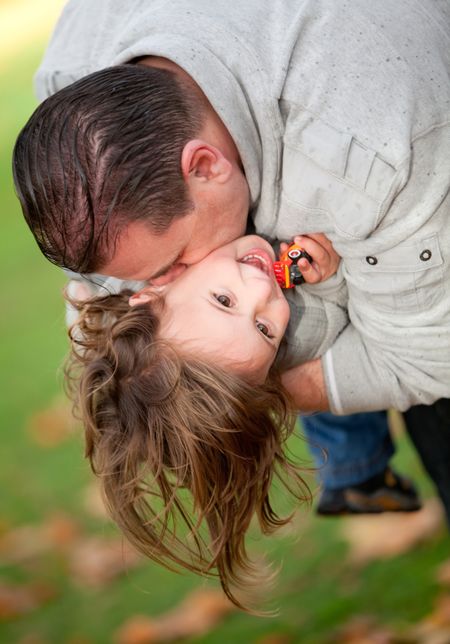 Father and son outdoors playing at the park - family concepts