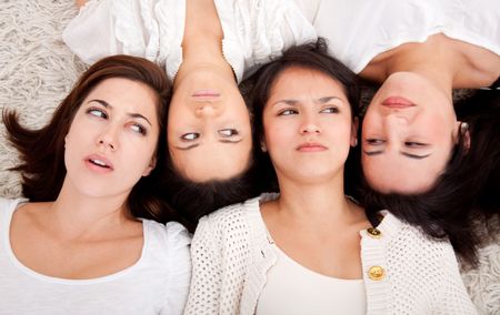 Group of women lying on the floor making faces