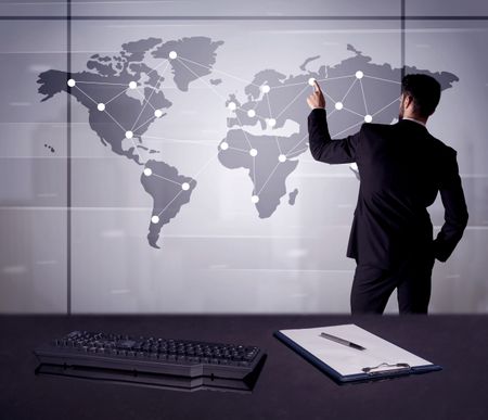 A young office worker drawing on world map and connecting dots with lines, presenting marketing sterategy at office environment concept