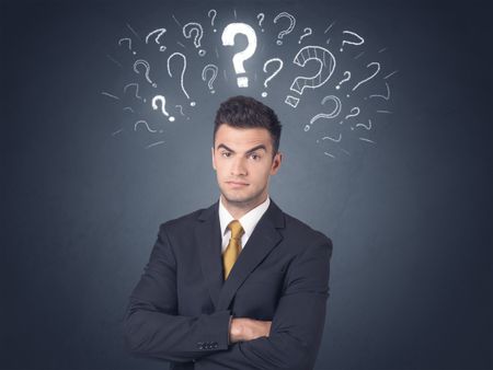 Young businessman with white question marks above his head