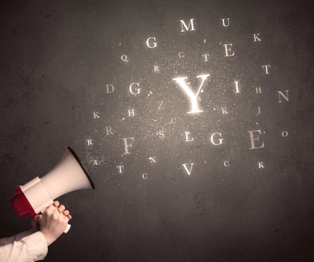 Caucasian arm holding megaphone with letter cloud