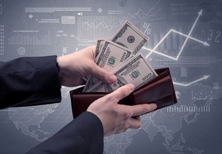 Businessman's hand takes out dollar from wallet with finance graphic on the background