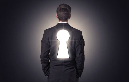 Young businessman standing and thinking with black keyhole on his back