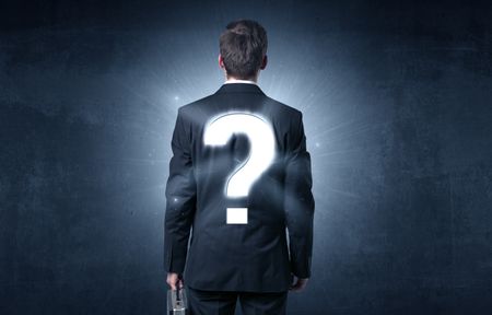 Businessman standing and thinking about questions