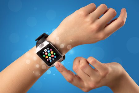 Naked female hand with smartwatch and with application icons on it