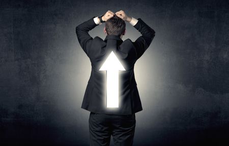 Young businessman standing and thinking about which direction to choose