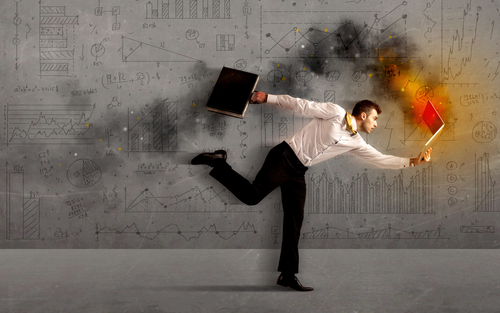 Running business man in a hurry with fire laptop concept