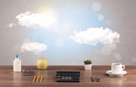 Close up of business office desk concept with clouds, blue sky and sunshine