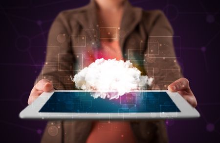 Casual young woman holding tablet with cloud concept and purple background 