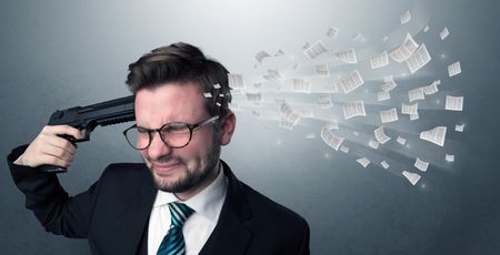 Handsome businessman shoots his head with gun and documents coming out from his head