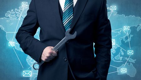 Businessman holding tool with global map graphic on the background