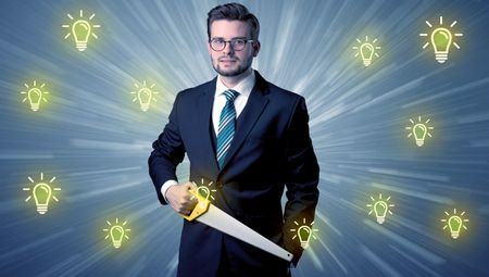 Better-looking businesman holding tool with idea bulbs concep