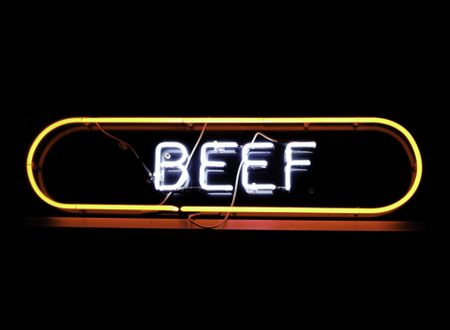 Neon sign in window of restaurant, isolated on black