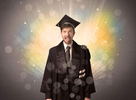 Happy graduate with colorful bokeg lights in the background grunge wall