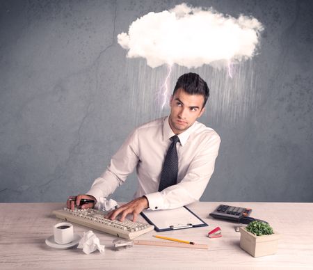 An elegant office worker is having a bad day while working, illustrated by a white cloud above his head with heavy rain and thunder concept