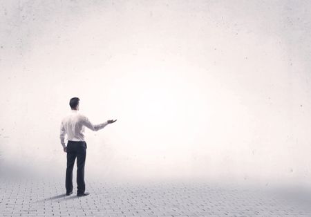 Serious business man standing on grey brick floor and thinging about decisions concept