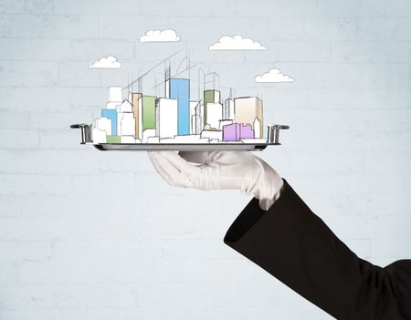 Serving a city concept with close up of waiter hand in gloves holding silver plate in front of grey brick wall