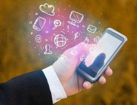 Hand holding smartphone with glowing multimedia icons 