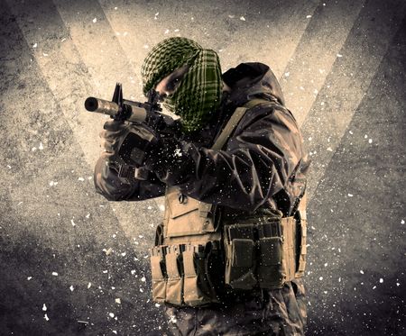 Portrait of a dangerous masked armed soldier with grungy light background