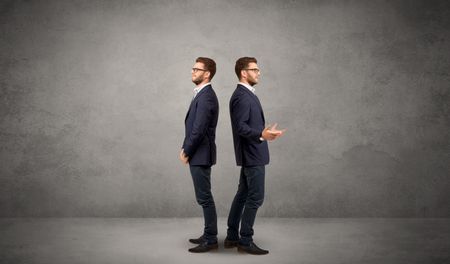 young-conflicted-businessman-choosing-two-directions-657528502 Young conflicted businessman choosing between two directions