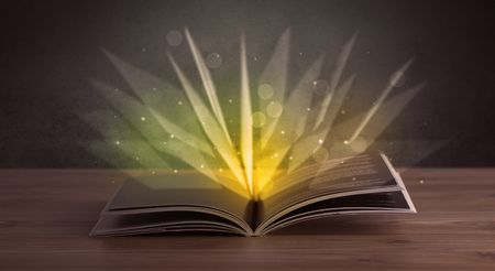 Yellow lights spreading from an open book 