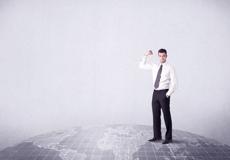 An elegant young male businessman standing on top of the world, pointing up concept with drawn earth map.