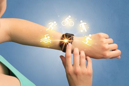 Female hand with smartwatch and sport concept.