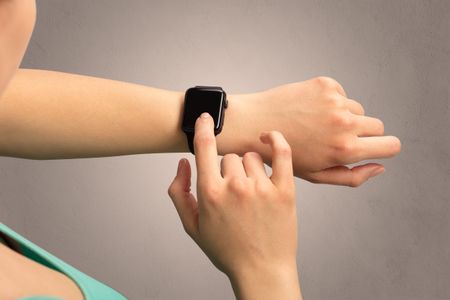 Female hand with black screen smartwatch.