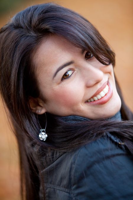 Portrait of a casual woman smiling outdoors